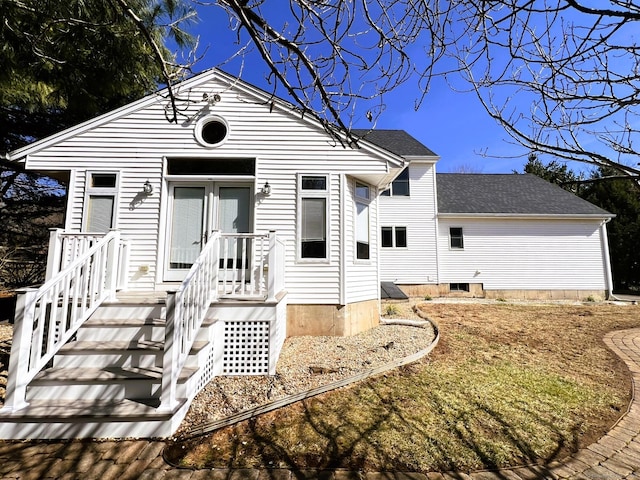 back of property with roof with shingles