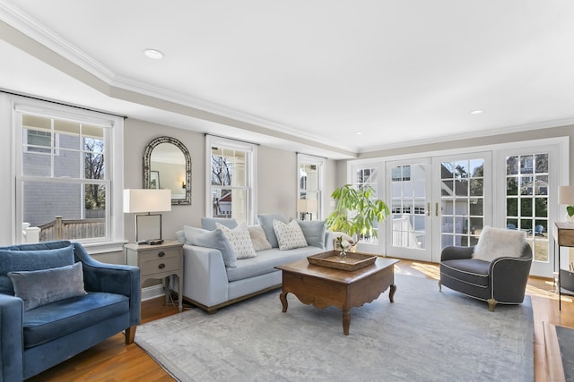 living room featuring recessed lighting, french doors, crown molding, and wood finished floors