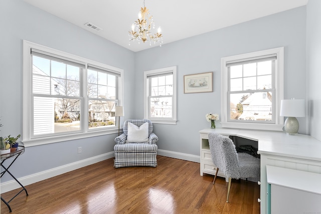 office featuring dark wood-style floors, visible vents, a notable chandelier, and baseboards