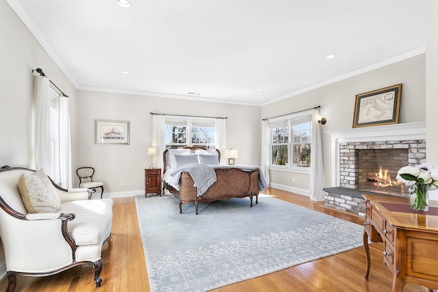 bedroom with recessed lighting, a fireplace, wood finished floors, baseboards, and ornamental molding