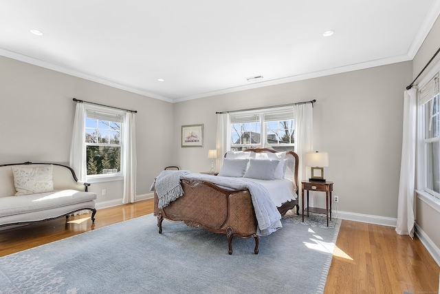 bedroom featuring light wood-style flooring, baseboards, and ornamental molding