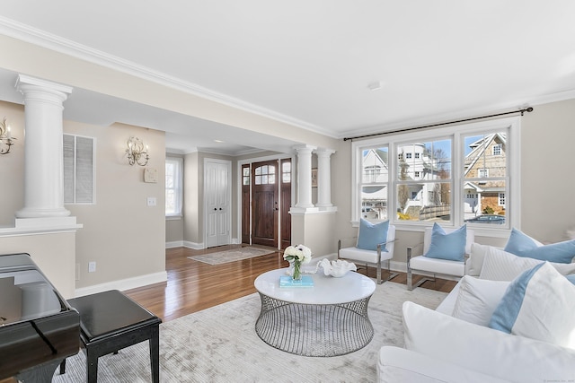 living area with visible vents, wood finished floors, and decorative columns