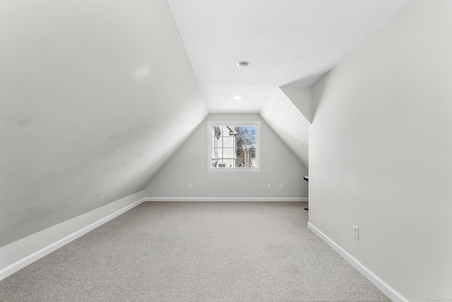 bonus room featuring lofted ceiling, carpet, and baseboards