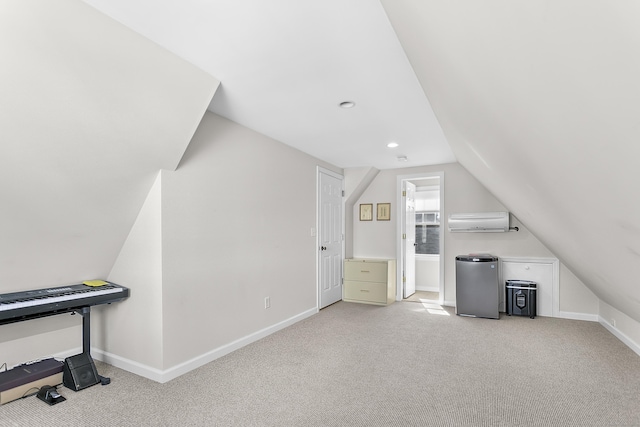 additional living space with baseboards, light colored carpet, vaulted ceiling, an AC wall unit, and recessed lighting