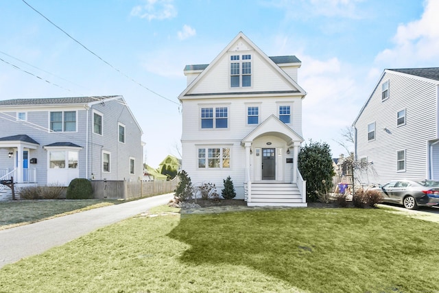 view of front of property with fence and a front yard