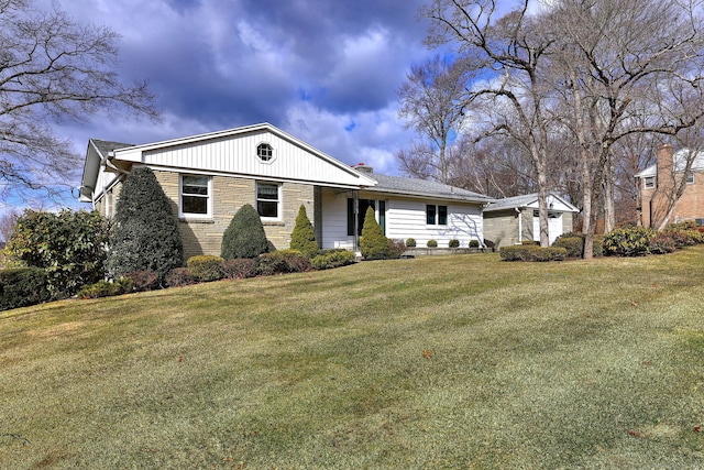 view of front facade featuring brick siding and a front yard