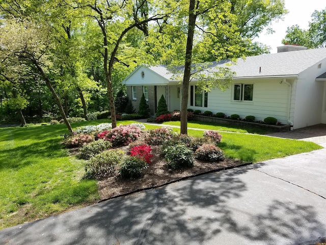 single story home with a front lawn and a chimney