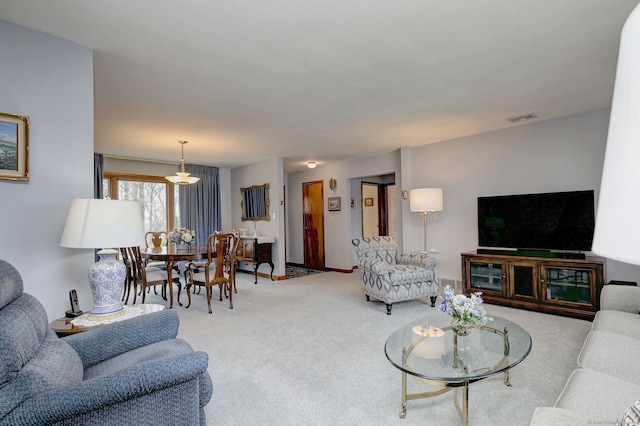 living room with visible vents and carpet floors