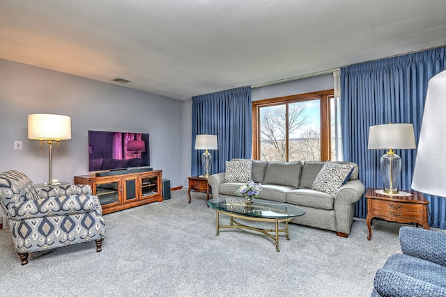 carpeted living area featuring visible vents