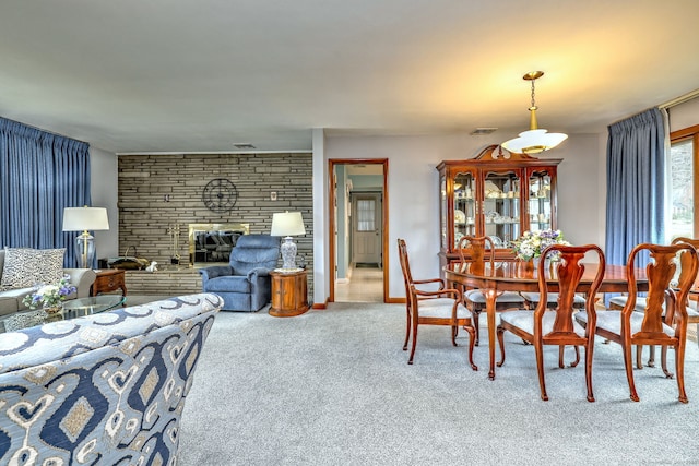 dining area featuring visible vents, a fireplace, baseboards, and carpet