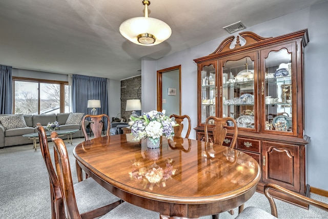 carpeted dining room with visible vents