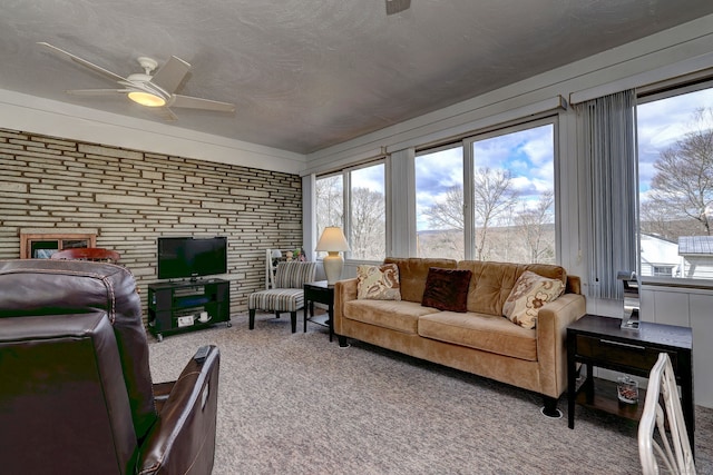 carpeted living area featuring a textured ceiling and a ceiling fan