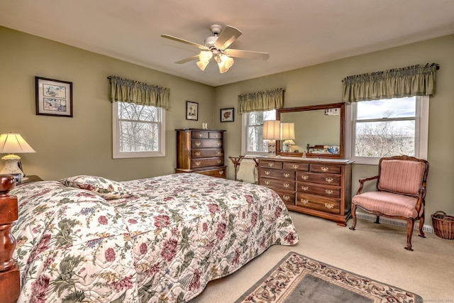 bedroom featuring multiple windows, ceiling fan, and carpet flooring