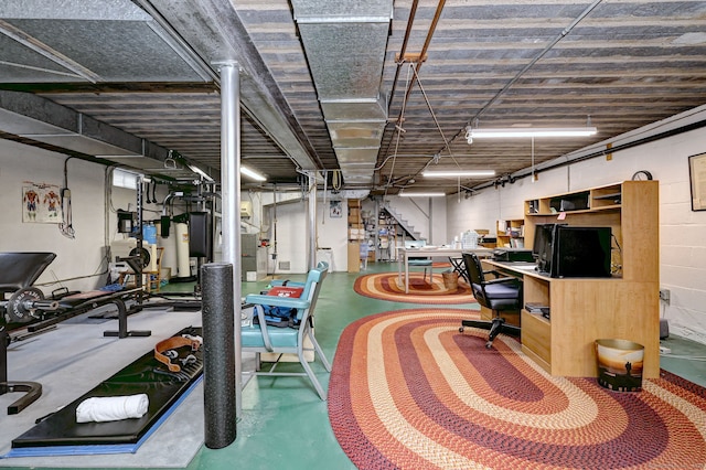 office area with concrete floors and concrete block wall