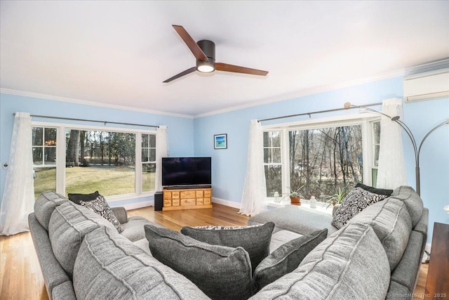 living area with crown molding, baseboards, and wood finished floors