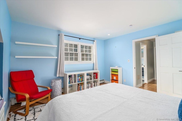 bedroom with wood finished floors and baseboards