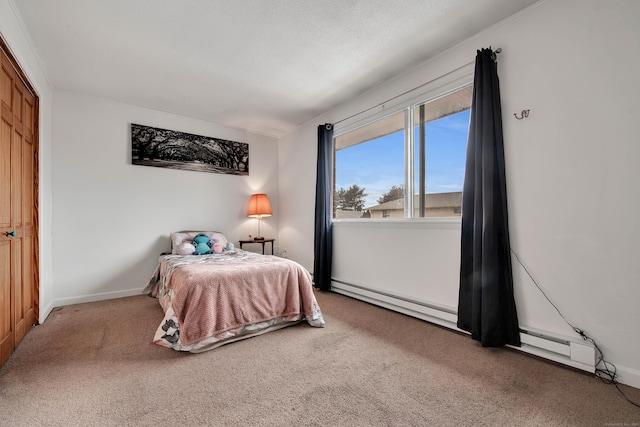 bedroom with baseboards, carpet, and baseboard heating