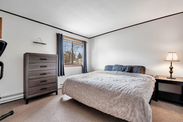 carpeted bedroom with baseboard heating, crown molding, and a baseboard heating unit