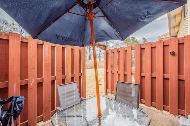 view of patio / terrace featuring outdoor dining space and fence