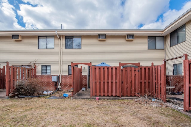 back of house with a yard and fence