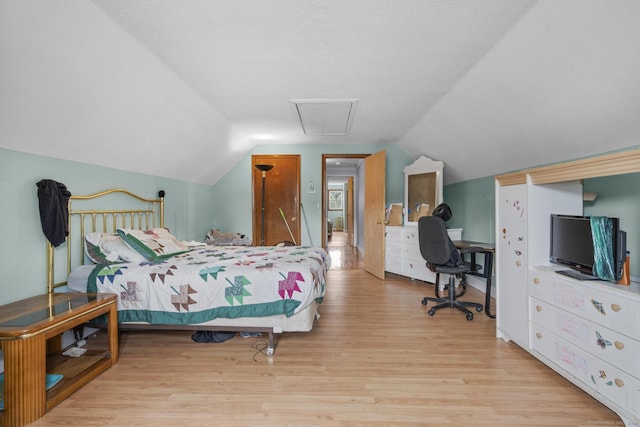 bedroom featuring lofted ceiling and wood finished floors