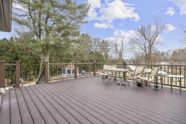 wooden terrace featuring outdoor dining area