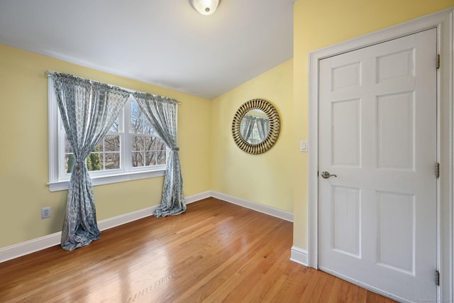 empty room featuring light wood-style flooring and baseboards