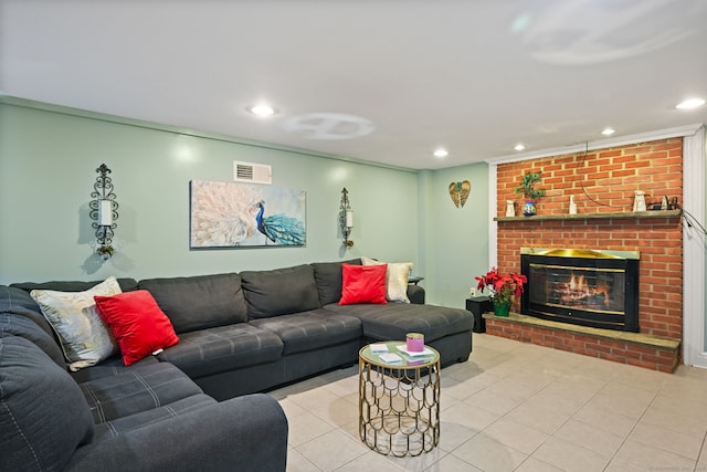 tiled living area featuring recessed lighting, a brick fireplace, and visible vents