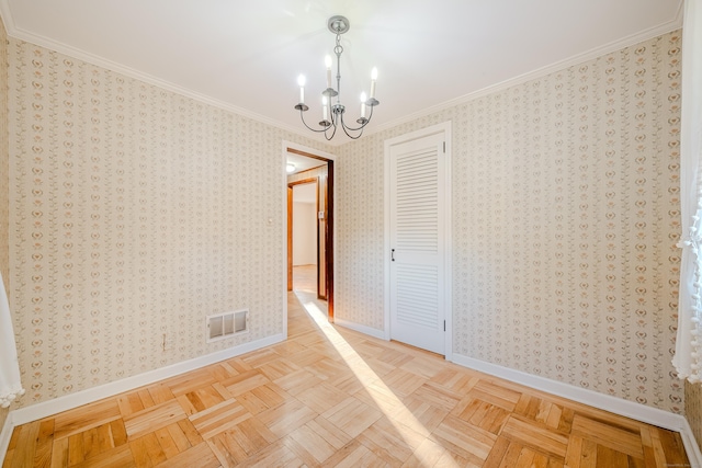 empty room featuring a notable chandelier, visible vents, baseboards, ornamental molding, and wallpapered walls