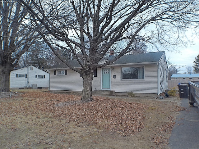 view of front of home featuring central air condition unit and a chimney