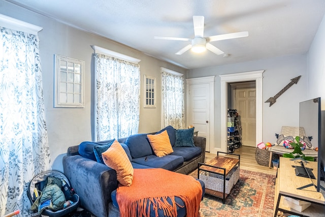 living room with a ceiling fan and wood finished floors