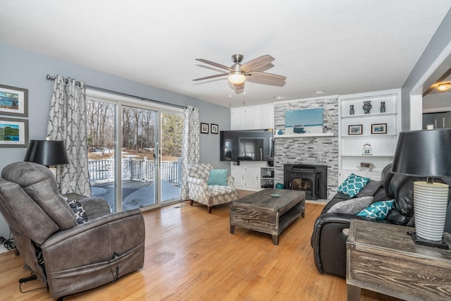 living room featuring light wood-style flooring and ceiling fan