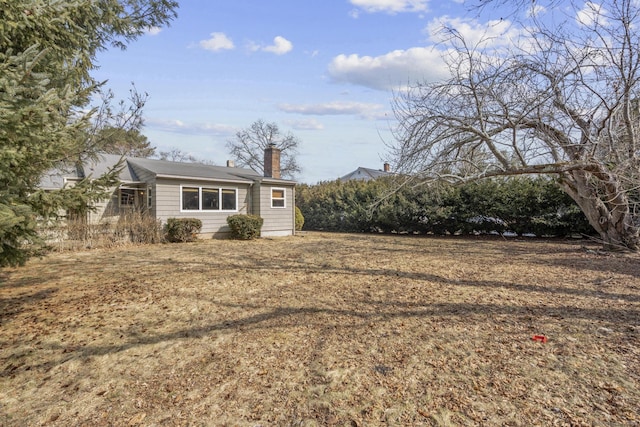 view of front of house featuring a chimney