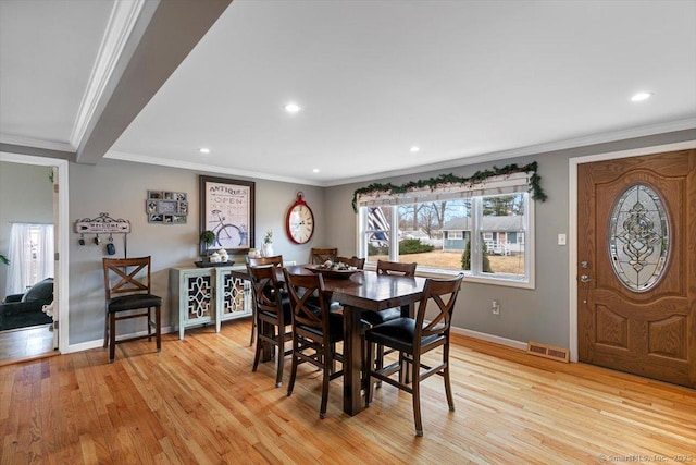 dining space featuring visible vents, baseboards, light wood-style flooring, ornamental molding, and recessed lighting