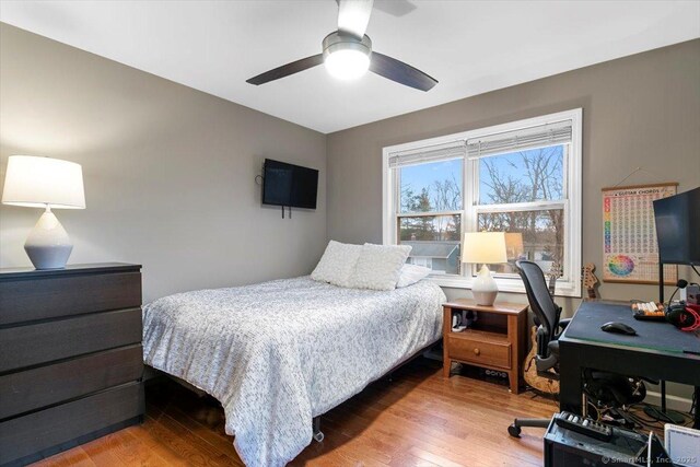 bedroom with ceiling fan and wood finished floors