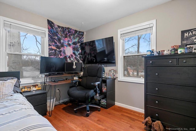 bedroom with baseboards and wood finished floors