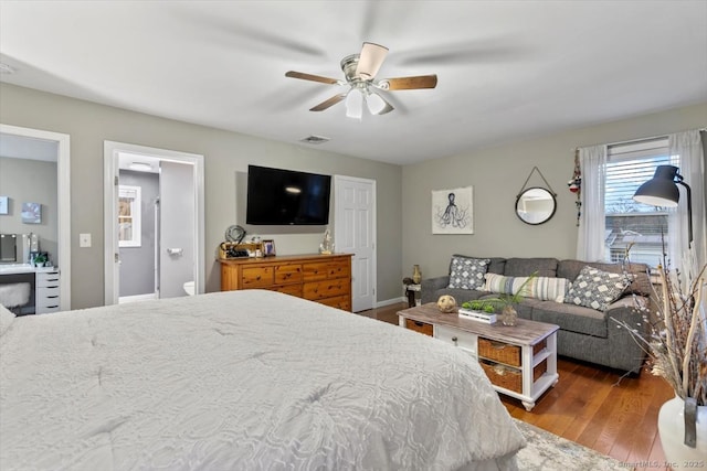 bedroom with wood-type flooring, visible vents, and ceiling fan