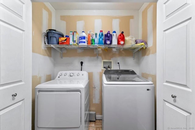 washroom featuring laundry area and washing machine and clothes dryer