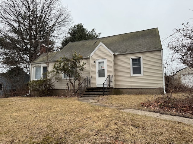 view of front of property with a chimney and a front lawn