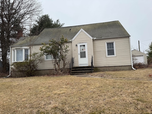 view of front of home featuring a garage, entry steps, and a front lawn