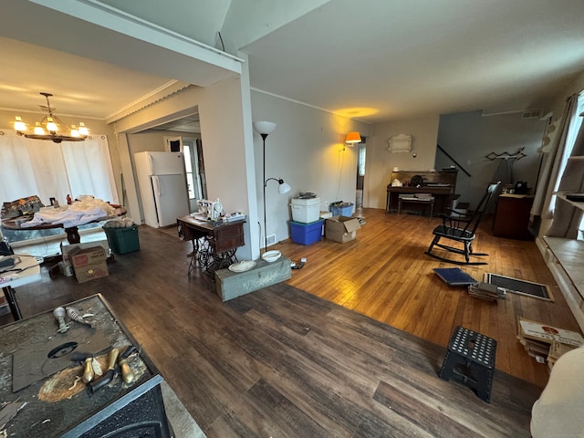 living room featuring a chandelier and wood finished floors