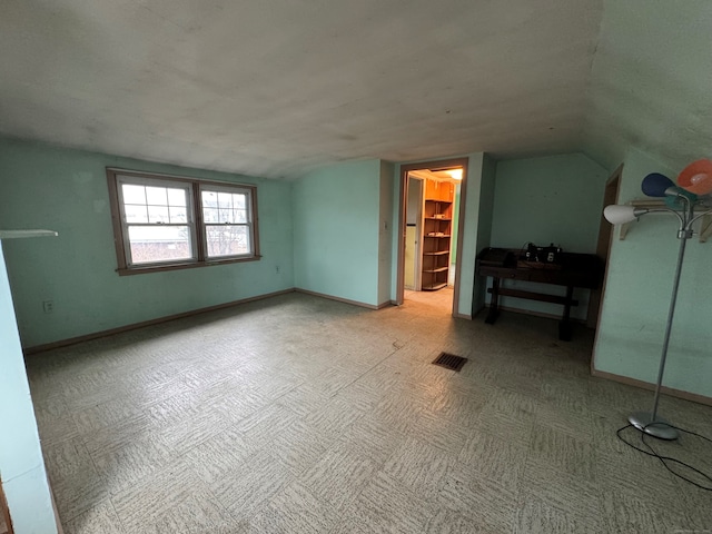 bonus room with visible vents, baseboards, and lofted ceiling