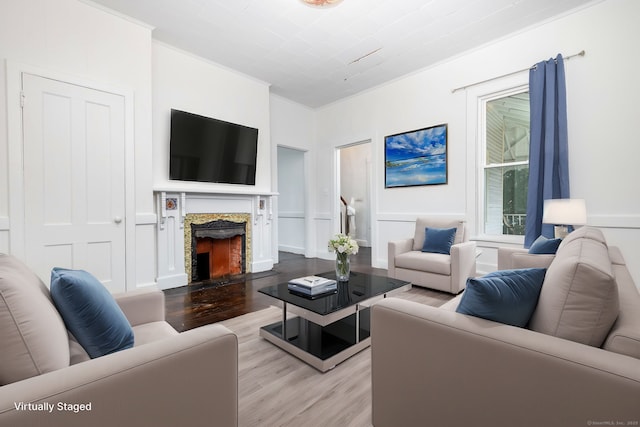 living room with wood finished floors and a fireplace