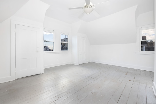 bonus room featuring baseboards, lofted ceiling, ceiling fan, and hardwood / wood-style flooring