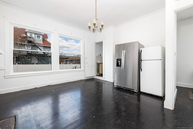 unfurnished dining area with dark wood finished floors, a notable chandelier, crown molding, and baseboards