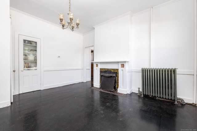 unfurnished living room with a fireplace with flush hearth, wood finished floors, radiator, crown molding, and a chandelier