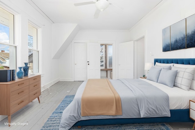 bedroom with light wood-style flooring, a ceiling fan, crown molding, and baseboards