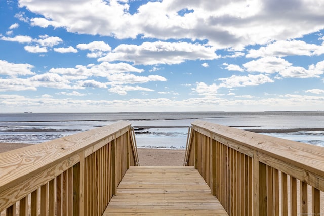 surrounding community featuring a beach view and a water view