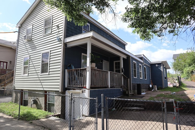 view of property exterior featuring a fenced front yard, a gate, and a porch