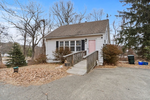 view of front of home with a shingled roof